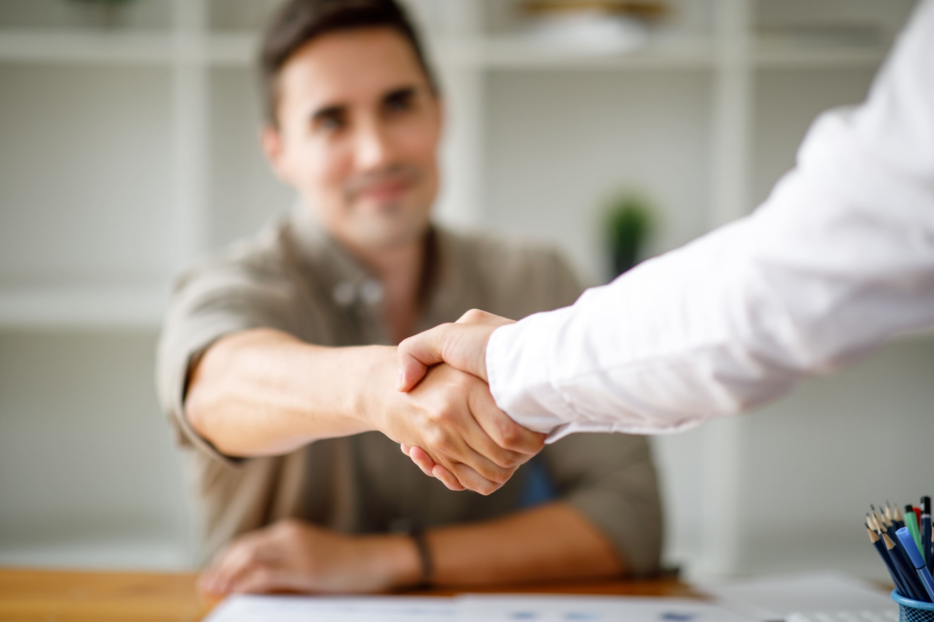 a close-up of a man shaking hands