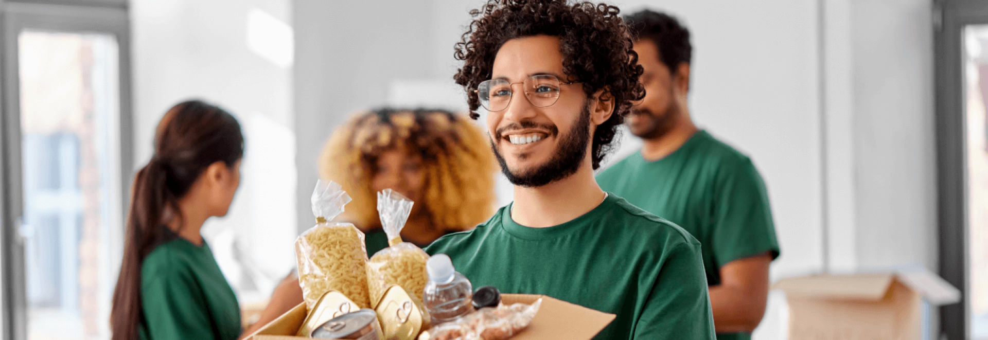 a man holding a box of food