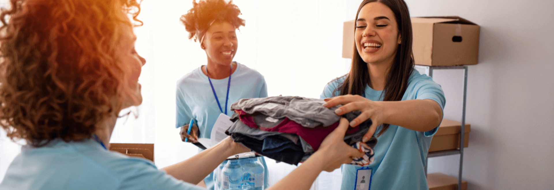 a group of women holding clothes