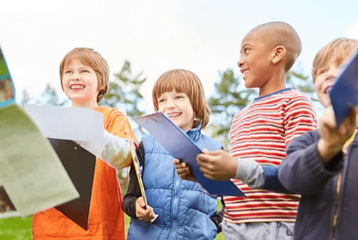 a group of children holding papers