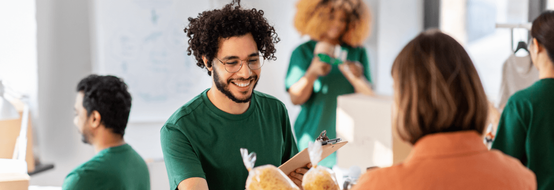 a man smiling at a clipboard