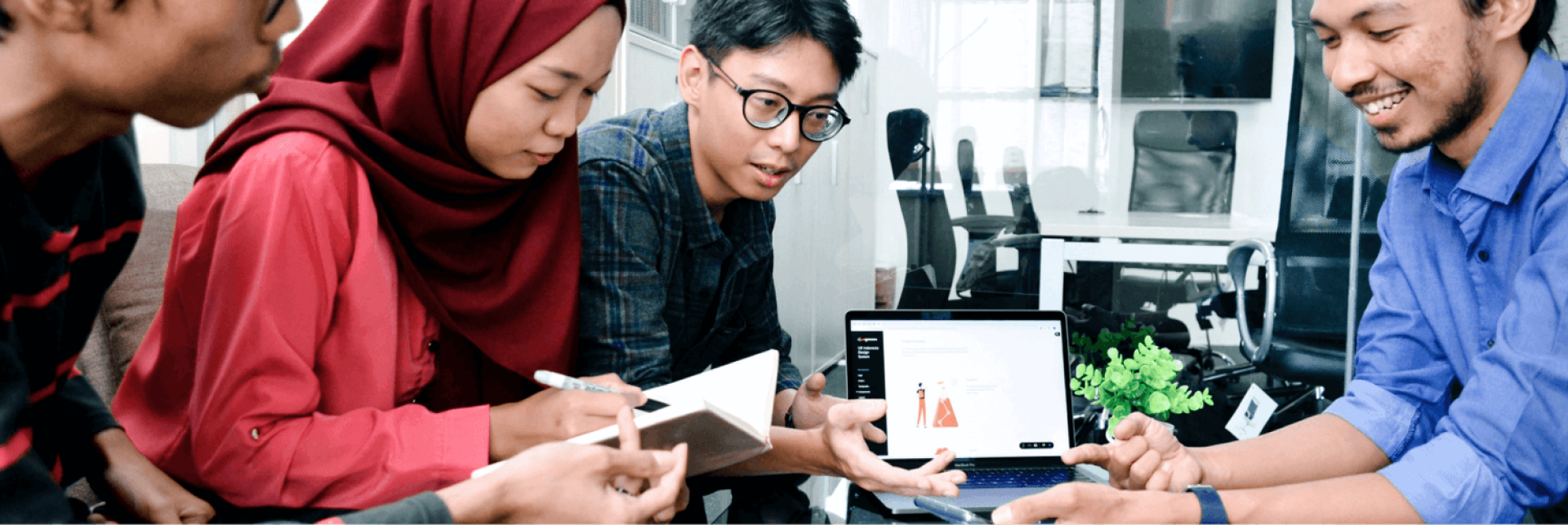 a person and person looking at a laptop