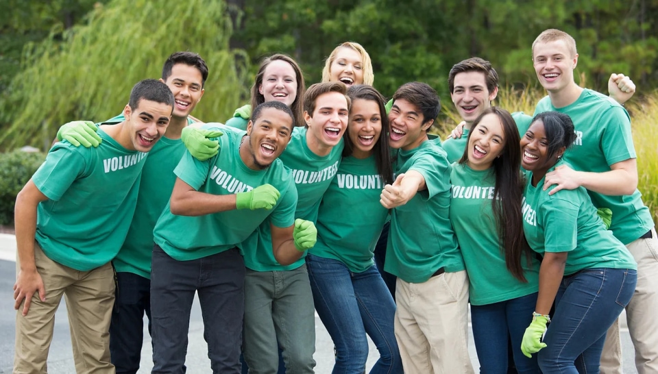 a group of people in green shirts