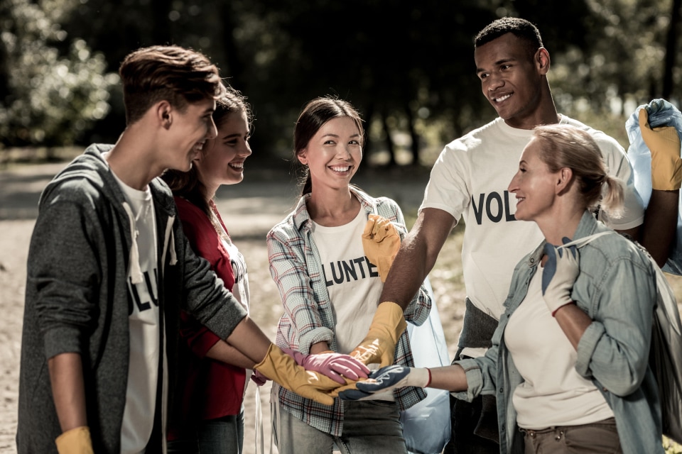 a group of people wearing gloves and holding a clipboard