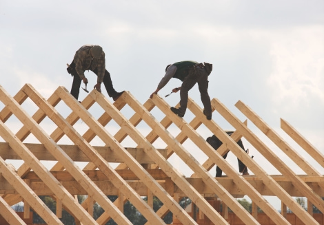 a group of men working on a roof